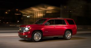 2019 Chevy Tahoe in red driving at night