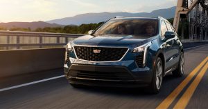 2020 Cadillac XT4 in blue driving down the road