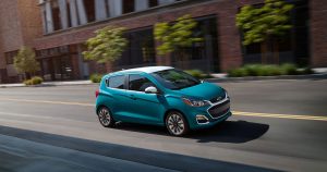 2021 Chevrolet Spark in a teal color driving down the road