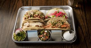 4 tacos with guac, pico de gallo, and sour cream on the side