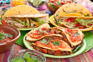 a full spread of tacos, salsa, and guacamole