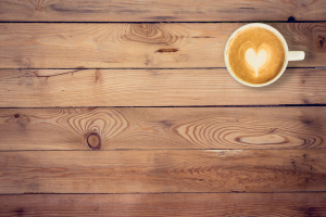 a latte on a wooden surface.