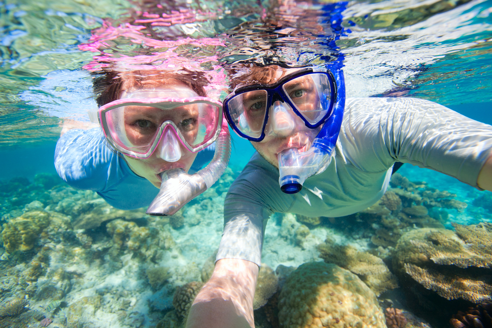 two people snorkeling in clear water