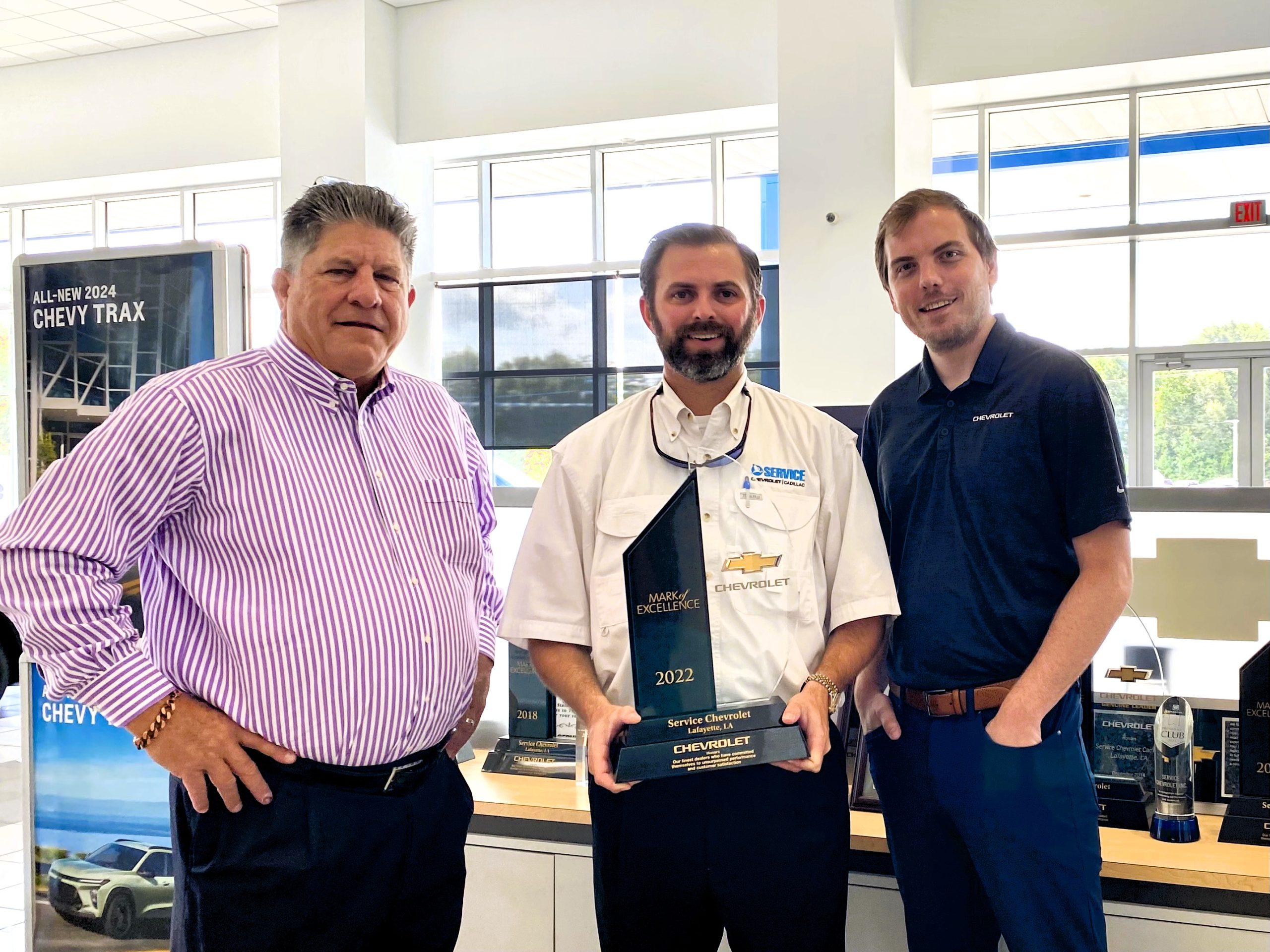 Service Chevrolet Cadillac employees receiving the Mark of Excellence Award from General Motors in 2022