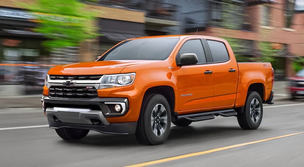 An orange 2021 Chevy Colorado Z71 is shown from the front at an angle after leaving a used Chevrolet dealer.
