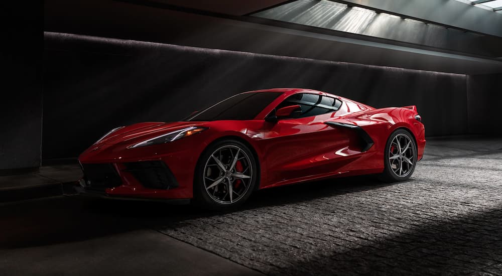 A red 2021 Chevy Corvette is shown from the side while parked in a tunnel.
