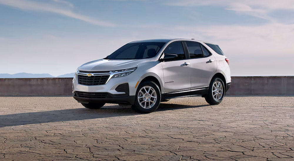 A silver 2024 Chevy Equinox LS overlooking mountains.