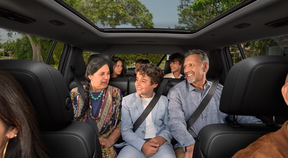 A family is shown sitting in a 2024 Chevy Traverse for sale.