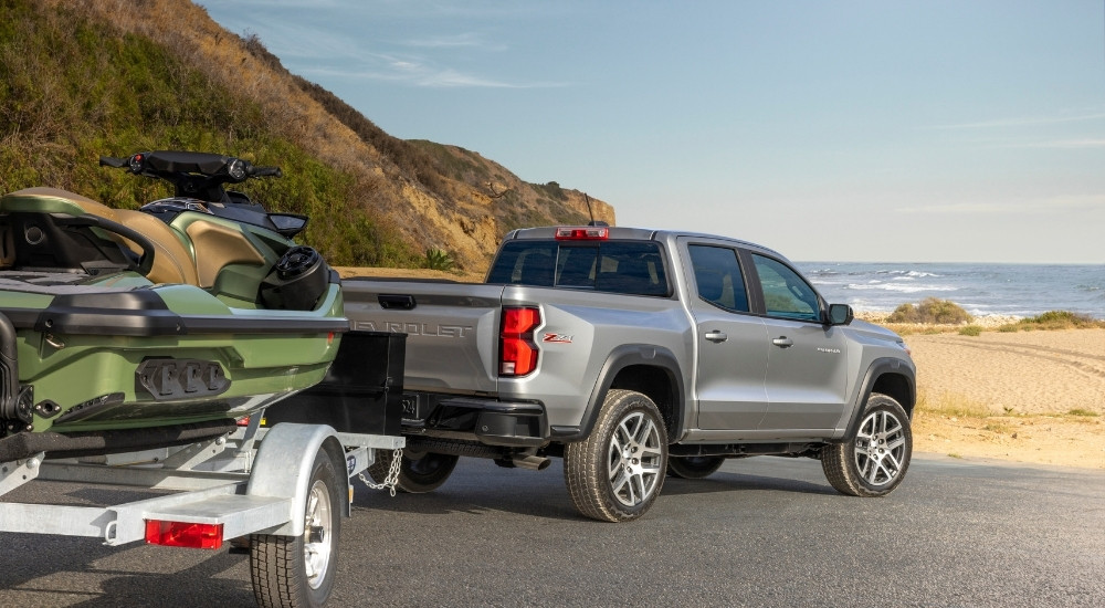 A silver 2024 Chevy Colorado Z71 is shown from the rear at an angle.