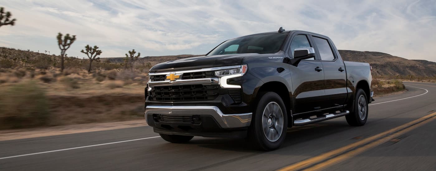 A black 2022 Chevy Silverado 1500 LT is shown from the front at an angle after leaving a Chevrolet dealer.